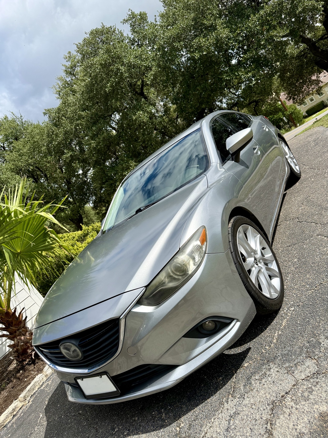 Silver Mazda sedan photographed outdoors